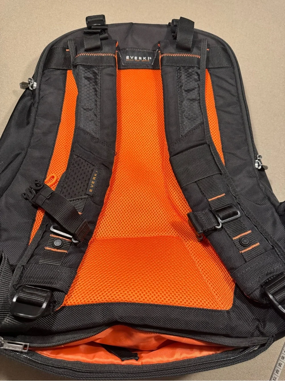 Black Men's Travel Backpack with Orange Accents Everki large laptop bag.